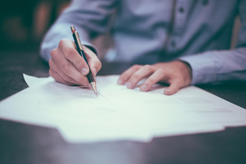 Client signing New York real estate closing documents